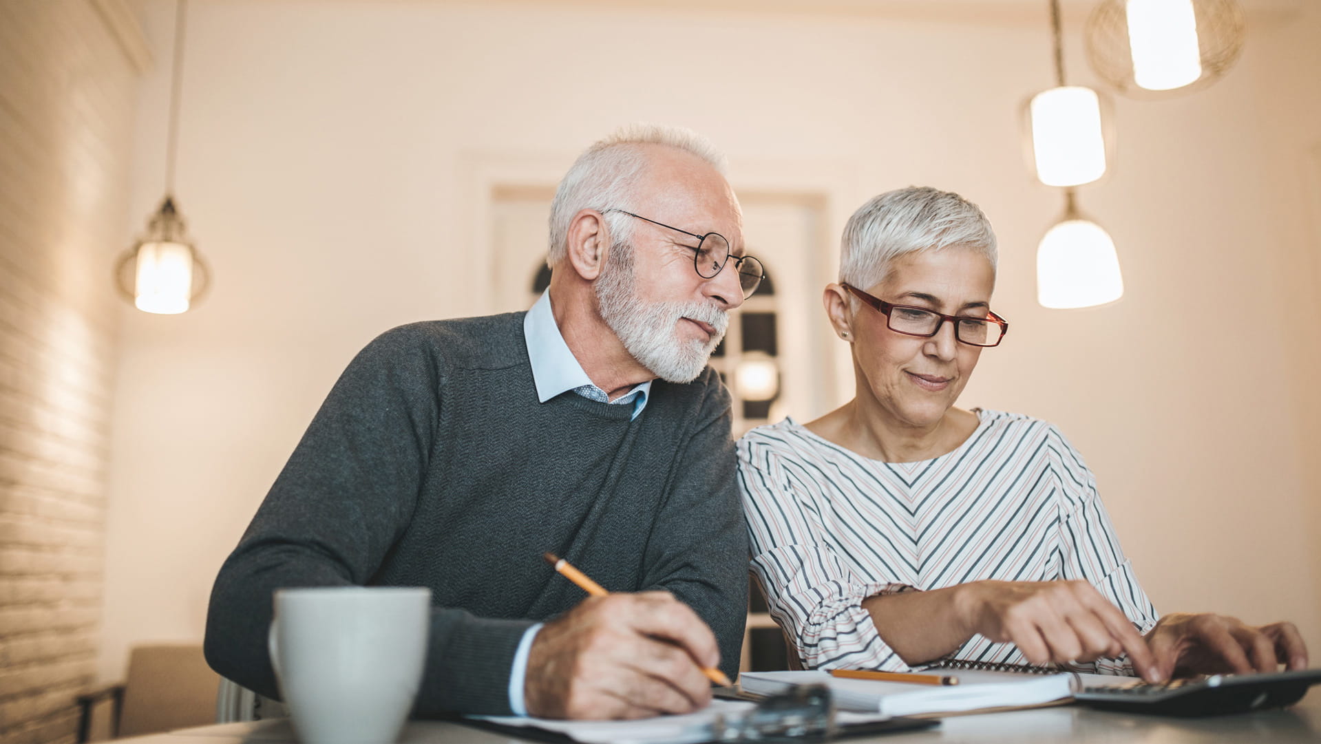 Man and woman calculating their super contributions