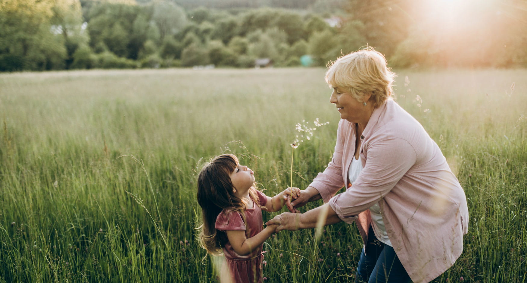 Woman and a girl playing in a field together